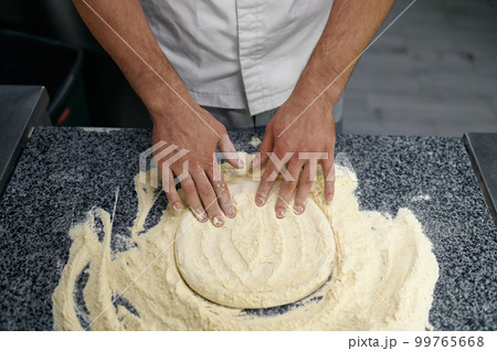 Midsection of man chef preparing food at professional kitchen Midsection of man chef preparing food at professional kitchen 99765668