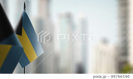 Small flags of the Bahamas on an abstract blurry background 99766590