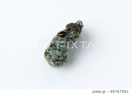 Natural chrysolite, olivine green color transparent raw crystal, close up, white background Natural chrysolite, olivine green color transparent raw crystal, close up, white background 99767891