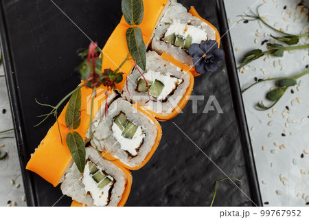 Rainbow Sushi Roll with salmon, eel, tuna, avocado, royal prawn, cream cheese Philadelphia, caviar tobica, chuka. Sushi menu. Japanese food.  99767952
