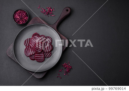 Delicious healthy boiled ruby-colored beets sliced on a black plate Delicious healthy boiled ruby-colored beets sliced on a black plate 99769014