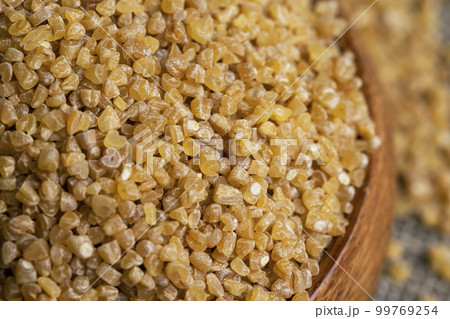 Fresh wheat porridge in a wooden bowl Fresh wheat porridge in a wooden bowl 99769254