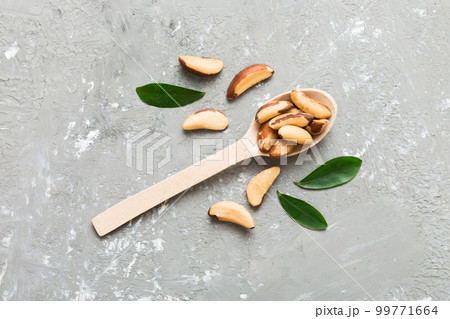 Fresh healthy brazil nuts in spoon on colored table background. Top view Healthy eating concept. Super foods Fresh healthy brazil nuts in spoon on colored table background. Top view Healthy eating concept. Super foods 99771664