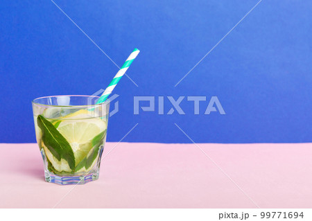 Mojito summer refreshing cocktail with ice and mint. mojito cocktail with lime, lemon and mint in a tall glass with a stick Mojito summer refreshing cocktail with ice and mint. mojito cocktail with lime, lemon and mint in a tall glass with a stick 99771694