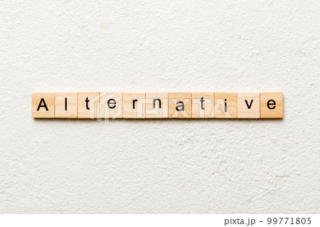 alternative word written on wood block. alternative text on table, concept 99771805