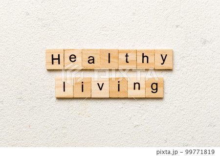 Healthy Living word written on wood block. Healthy Living text on cement table for your desing, concept Healthy Living word written on wood block. Healthy Living text on cement table for your desing, concept 99771819