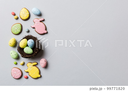 Colorful easter eggs in nest on table background with copy space top view 99771820