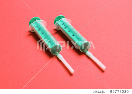 Top view of medical syringes on colorful background with copy space. Injection equipment concept Top view of medical syringes on colorful background with copy space. Injection equipment concept 99772080