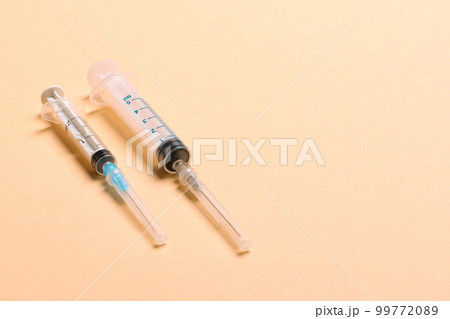 Top view of medical syringes on colorful background with copy space. Injection equipment concept 99772089