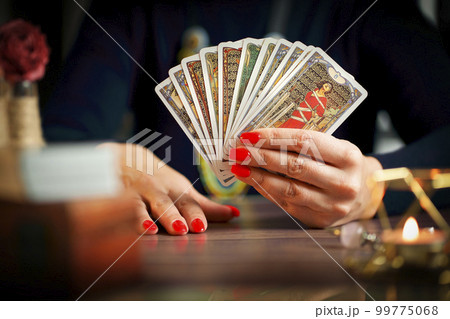 Blurred tarot cards on the table, esoteric concept, fortune telling predictions 99775068