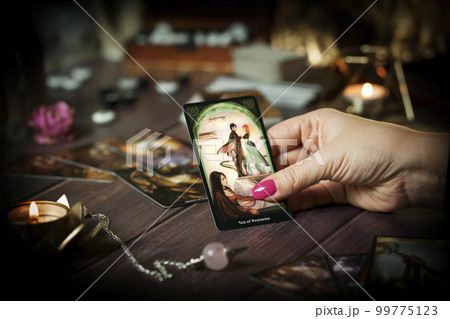 Blurred tarot cards on the table, esoteric concept, fortune telling predictions Blurred tarot cards on the table, esoteric concept, fortune telling predictions 99775123