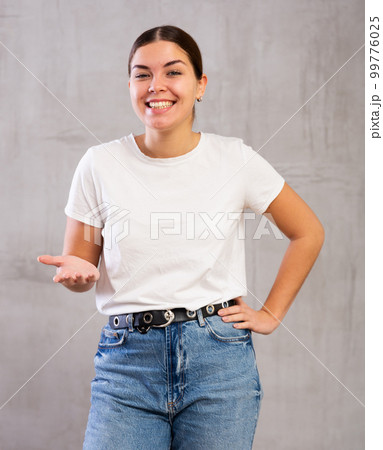 Smiling young woman posing in casual clothes 99776025