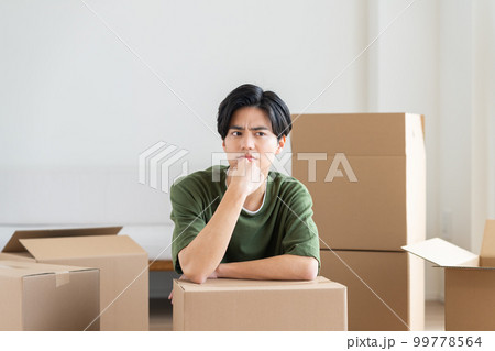 引越しで悩む若い男性　 99778564