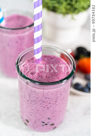 Freshly made mixed berry boba smoothie in a drinking jar with paper straw. 99784382