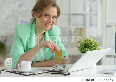 Woman working on laptop 99788865