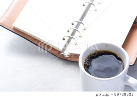 システム手帳とコーヒーでデスクワーク 99789903