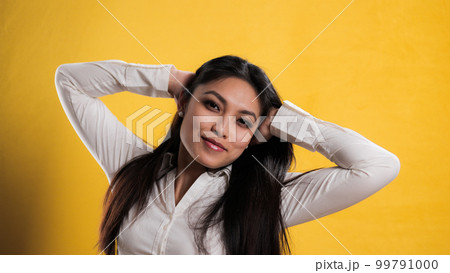 Young pretty woman with Asian appearance posing for the camera 99791000