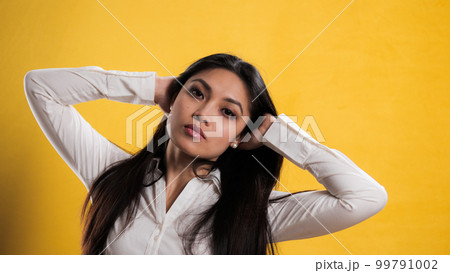 Young pretty woman with Asian appearance posing for the camera 99791002