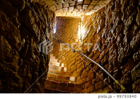 Old spiral staircase inside red brick tower. Turaida Castle tower Old spiral staircase inside red brick tower. Turaida Castle tower 99793840