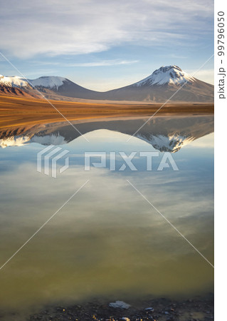 Salt lake Lejia reflection, idyllic volcanic landscape at Sunset, Atacama, Chile 99796050