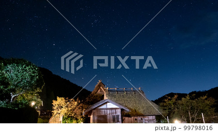 茅葺屋根の向こうにオリオン座の出 99798016