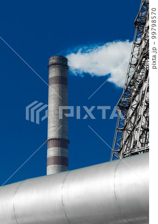 Pollution of the environment, atmosphere, air, environmental problems. Smoke is emitted from the industrial steam pipe of the plant tower Pollution of the environment, atmosphere, air, environmental problems. Smoke is emitted from the industrial steam pipe of the plant tower 99798570