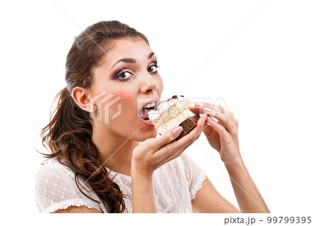 Woman eating cake 99799395