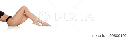 Slender female legs on light background. Depilation, epilation, laser hair removal. Concept of body and skin care, fitness, natural beauty, health Banner, flyer. Slender female legs on light background. Depilation, epilation, laser hair removal. Concept of body and skin care, fitness, natural beauty, health Banner, flyer. 99800192
