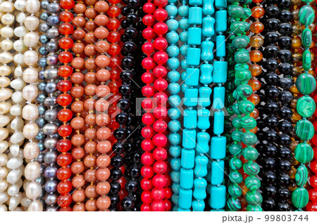 Stack of colorful necklaces for sale 99803744