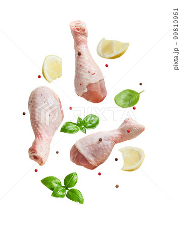 Raw flying chicken drumstick And spices cut out on a white background 99810961
