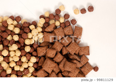 Quick breakfasts on white background - chocolate pads and balls, top view Quick breakfasts on white background - chocolate pads and balls, top view 99811129