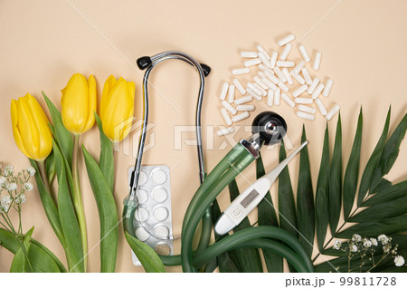 Bouquet of flowers and stethoscope on a beige background, happy doctors day, nurses week and other medical holidays. Bouquet of flowers and stethoscope on a beige background, happy doctors day, nurses week and other medical holidays. 99811728