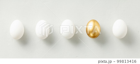 White chicken eggs with one golden egg flat lay top view banner White chicken eggs with one golden egg flat lay top view banner 99813416