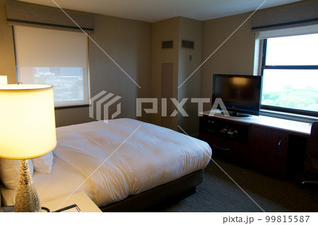 CHICAGO, ILLINOIS, UNITED STATES - MAY 11, 2018: KIng-size hotel bed in luxury hotel overlooking Lake Michigan CHICAGO, ILLINOIS, UNITED STATES - MAY 11, 2018: KIng-size hotel bed in luxury hotel overlooking Lake Michigan 99815587