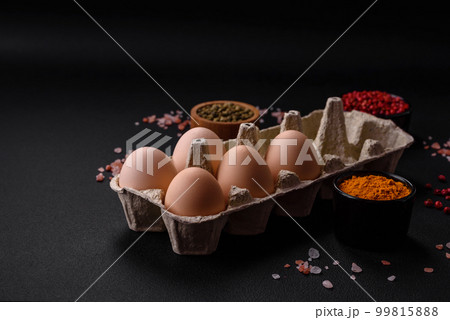 Fresh raw chicken eggs in beige color in a cardboard tray Fresh raw chicken eggs in beige color in a cardboard tray 99815888