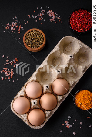 Fresh raw chicken eggs in beige color in a cardboard tray Fresh raw chicken eggs in beige color in a cardboard tray 99815890