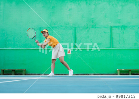 female tennis player ready to receive ball while holding racket female tennis player ready to receive ball while holding racket 99817215