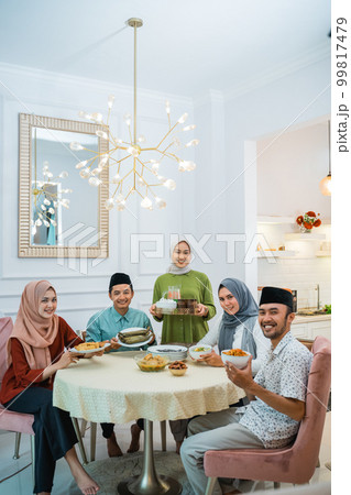happy family look at camera together in the dining room happy family look at camera together in the dining room 99817479