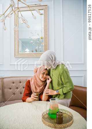 Muslim woman in hijab has a sad and crying friend Muslim woman in hijab has a sad and crying friend 99817516