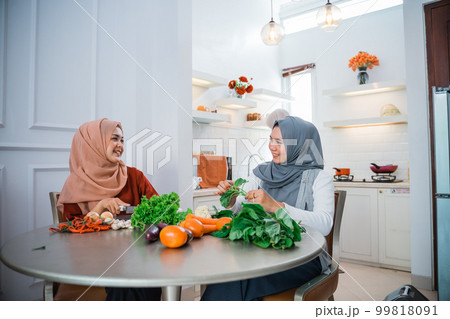 muslim woman friend preparing some food for dinner 99818091