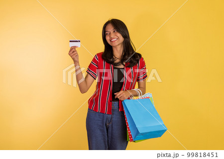 asian woman showing the blank card while holding the shopping bags 99818451