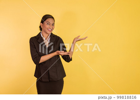 asian woman in formal outfit standing an pointing on her side asian woman in formal outfit standing an pointing on her side 99818816