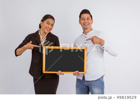 asian couple holding the blackboard together with pointed finger 99819029