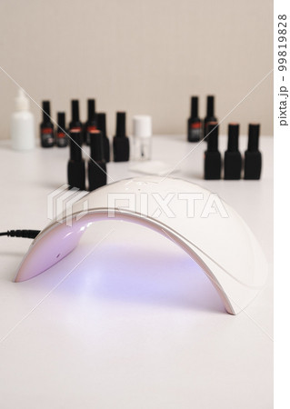 Ultraviolet LED lamp for drying gel nail polish and jars with gel polishes. Manicure and pedicure. Ultraviolet LED lamp for drying gel nail polish and jars with gel polishes. Manicure and pedicure. 99819828