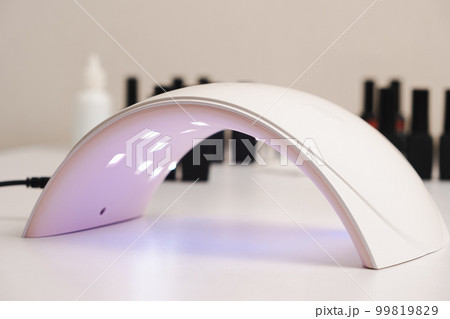 Ultraviolet LED lamp for drying gel nail polish and jars with gel polishes. Manicure and pedicure. Ultraviolet LED lamp for drying gel nail polish and jars with gel polishes. Manicure and pedicure. 99819829