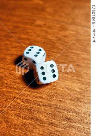 Close-up of two dice with rolled sixes on a wooden table Close-up of two dice with rolled sixes on a wooden table 99820971