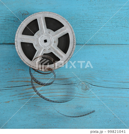 Old film strip on wooden background. 99821041