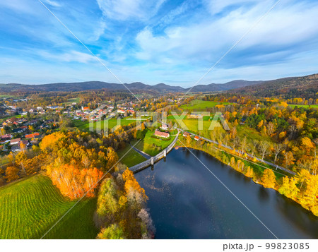 Fojtka water reservoir surrounded by vibrant colored forest at autumn time. Aerial view from drone. Fojtka water reservoir surrounded by vibrant colored forest at autumn time. Aerial view from drone. 99823085