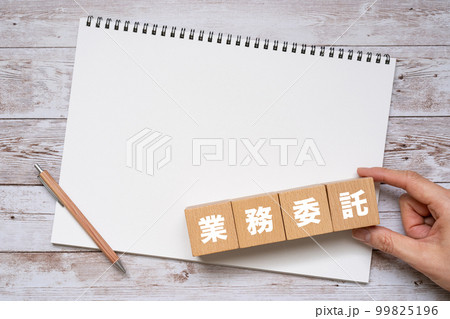 業務委託と書かれたブロック、ノート、ペン、手 99825196