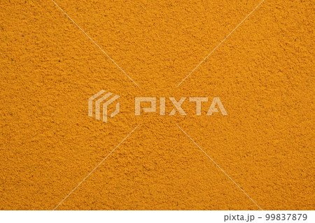 Poured turmeric powder spice background. Dry seasoning turmeric. Spices and herbs for cooking, curcuma 99837879